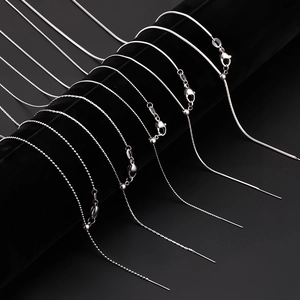 Adjustable silver stainless steel snake and bead chains displayed on a black stand