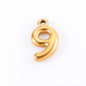Macro detail of a 18K gold-plated bubble number 9 pendant for DIY jewelry crafting