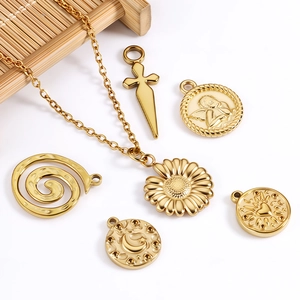 Detailed close-up of 18k gold plated stainless steel sun and heart pendant charms