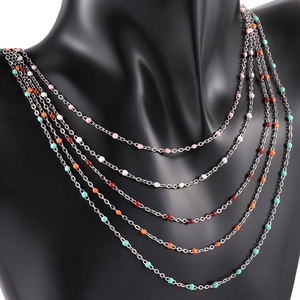 Five-layer silver stainless steel necklace featuring colorful enamel beads on a black bust