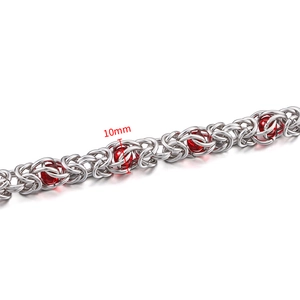 Detail of 10mm wide stainless steel Byzantine chain with decorative red beads