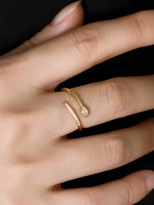 Macro detail of adjustable gold ring with marquise and round cubic zirconia stones