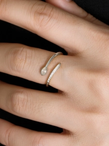Macro shot of silver open ring with marquise and pavé cubic zirconia on hand