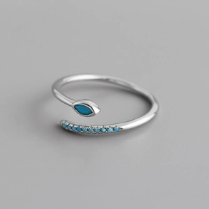 Detail of S925 sterling silver bypass ring featuring turquoise and blue zircon stones