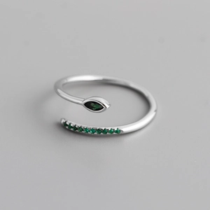 Macro detail of S925 silver snake ring featuring marquise green zircon and side stones