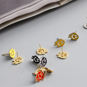 Macro shot of S925 sterling silver melting face stud earrings with colorful enamel