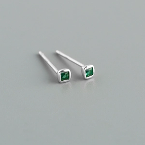 Detailed view of square cut green zircon earrings with polished silver metal base