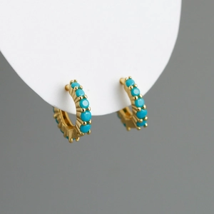 Détail des boucles d'oreilles créoles en argent s925 avec pierres turquoise et or
