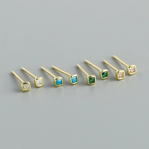 Close-up of square cut crystal stud earrings in gold finish showing various colors
