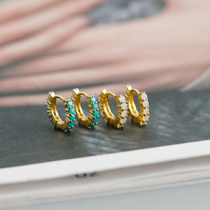Détails macro des boucles d'oreilles en argent S925 doré avec opale et turquoise
