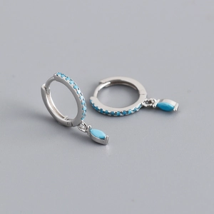 Macro view of S925 silver hoop earrings featuring turquoise stones and marquise pendants