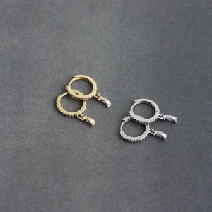Close-up of S925 silver hoop earrings with marquise purple stones in gold and silver