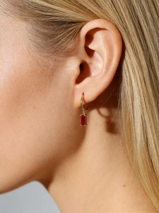 Élégantes créoles en argent S925 doré avec zircon rouge rectangulaire sur un mannequin