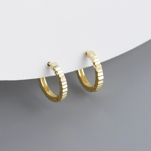 Pendientes de aro en plata S925 con diseño de engranaje texturizado y acabado dorado