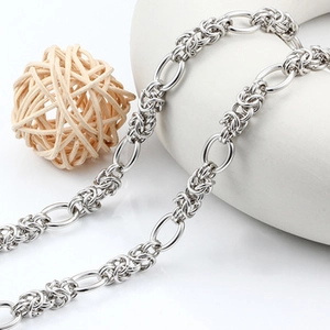 Macro shot of silver stainless steel Byzantine chain with oval links on display