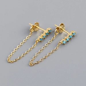 Detail view of S925 sterling silver tassel earrings with gold plating and blue stones