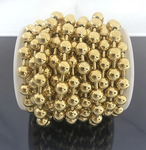 Macro detail of 3mm gold stainless steel bead chain wound neatly on a spool