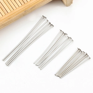 Macro detail of polished stainless steel flat head pins in three sizes for DIY jewelry