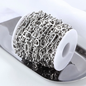 Silver stainless steel heart and oval link chain on white spool for DIY jewelry making
