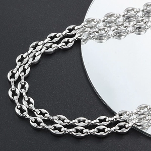 Industrial silver stainless steel coffee bean link chain necklace on mirror background