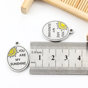 Detailed scale measurement showing the 20mm diameter of the sun engraved steel pendant