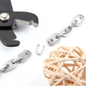 Polished stainless steel pig nose chain for DIY jewelry making being cut with pliers