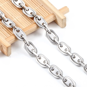 Polished stainless steel coffee bean link chain necklace on a bamboo tray background