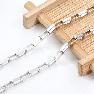 Polished stainless steel rectangle link chain displayed on a bamboo tray for DIY jewelry