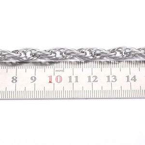 Macro shot of a 3mm silver twisted rope chain showing its thickness with a scale ruler