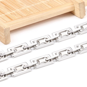 Polished silver stainless steel rectangular chain necklace on a white surface