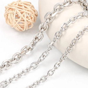 Macro view of three different thicknesses of polished stainless steel cable chain links