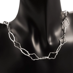Detailed view of silver stainless steel cross chain on mannequin showing texture