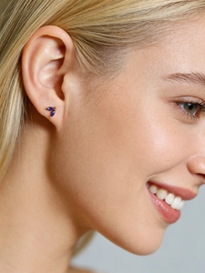 Close-up of elegant s925 silver stud earrings with blue marquise-cut zircon on ear