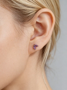 Detail shot of a minimalist S925 silver stud earring with marquise-cut purple zircons
