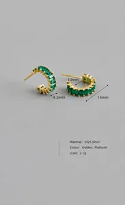 Detail view of gold S925 silver C-shaped earrings with emerald green square zircon