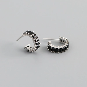 Detailed close-up of S925 silver stamp and black zircon inlay on C-shaped stud earrings