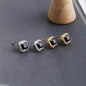 Detailed macro shot of S925 sterling silver square earrings with black zircon and pavé diamonds
