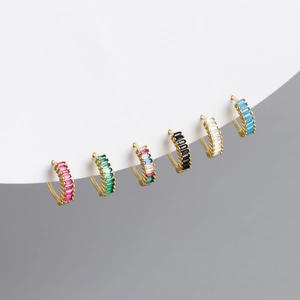 Macro detail of S925 silver huggie earrings with colorful baguette-cut zircon gemstones