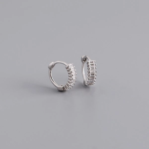 Macro detail of S925 silver hoop earrings with baguette-cut clear zircon stones