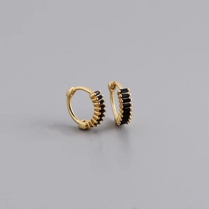 Detail of gold-plated silver huggie earrings with rectangular black cubic zirconia