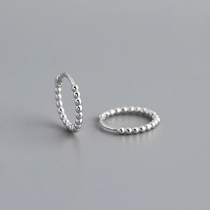 Detail of S925 sterling silver hoop earrings with a minimalist beaded ball pattern design