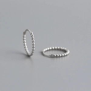 Detail shot of S925 sterling silver hoop earrings with a textured bead dot design