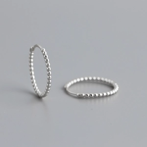 Detailed view of S925 sterling silver hoop earrings with a continuous bead design texture