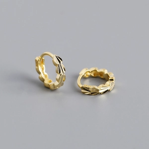 Close-up of S925 sterling silver earrings with textured leaf patterns and hallmarks