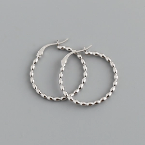 Close-up of S925 sterling silver hoop earrings with textured oval bead pattern detail