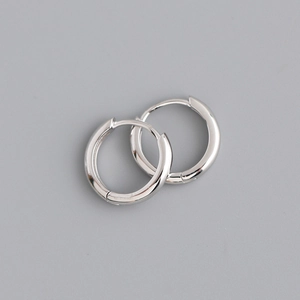 Macro detail of polished 925 sterling silver hoop earrings with high mirror finish