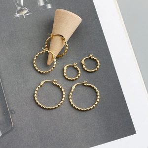 Three pairs of golden S925 sterling silver hoop earrings with textured beaded design