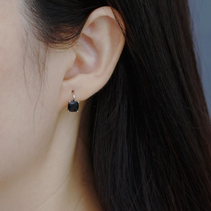 Close-up of square black zircon earrings in S925 sterling silver on woman's ear
