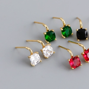 Close-up of square-cut colorful gemstones in gold claw settings with S925 hallmark