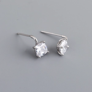 Detail of square-cut clear zircon stone in a 4-prong silver stud earring setting